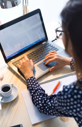 A woman typing on a laptop
