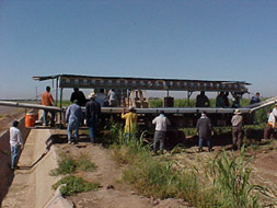 People in shaded area with cool water containers