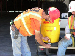 Man getting water from water container