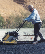 Laborer working on tarmac