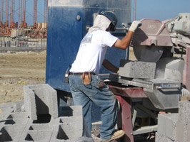 Worker cutting concrete block