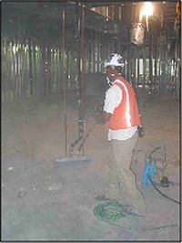 Worker cleaning up construction debris containing silica