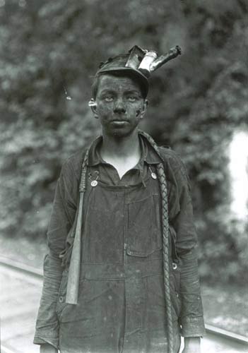 Photo of a child mining laborer, taken in the US in the early 20th century.