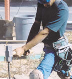Laborer hammering in a stake
