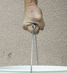 A hand holding a typical bucket handle 