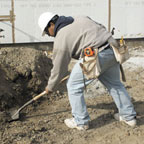 Laborer shoveling dirt