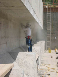 Worker grinding concrete surface