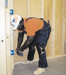 Carpenter kneeling on concrete floor