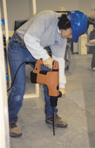 Carpenter using electric rip saw