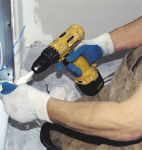 Carpenter working while kneeling