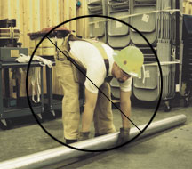 Carpenter lifting a heavy beam by himself
