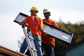Workers installing solar panels