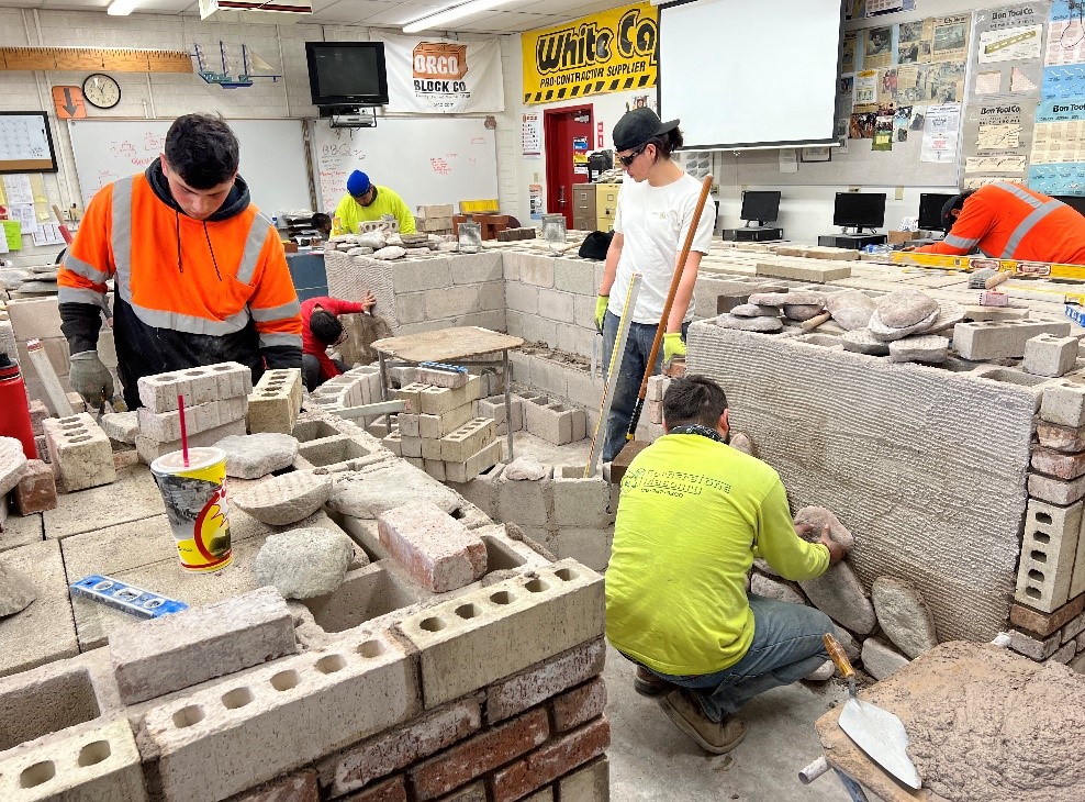Masons lay Concrete Block in classroom