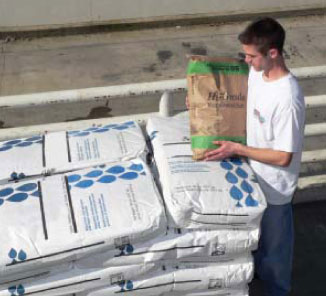 A guy lifting a smaller sack