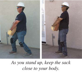 As you stand up, keep the sack close to your body