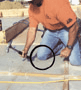 Carpenter kneeling on concrete floor
