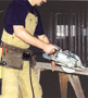 Carpenter using electric rip saw