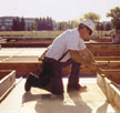 Carpenter working while kneeling