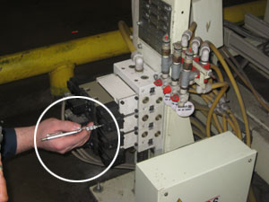Using a tool to verify there is no air pressure in the line