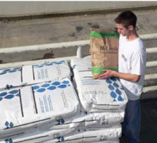 A guy carrying a smaller container