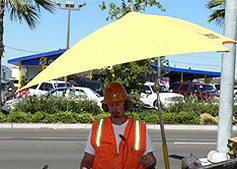 Construction worker standing in the shade.