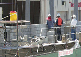 People working on construction site near water container