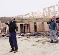 2 workers carrying a beam