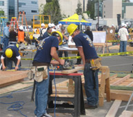 2 people working using a power tool