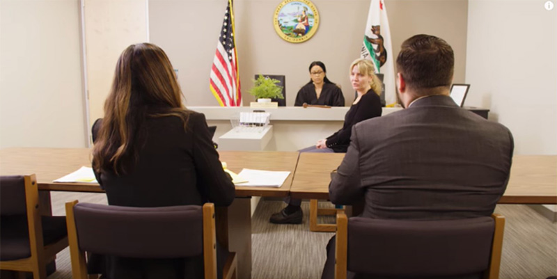 two attorneys sitting in front of a judge